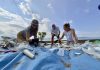3 femmes ramassent des plastiques sur une plage